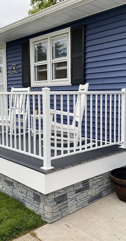 Small front porch with white railing.